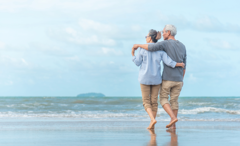 Older couple walking on the beach