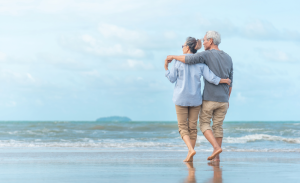 Older couple walking on the beach